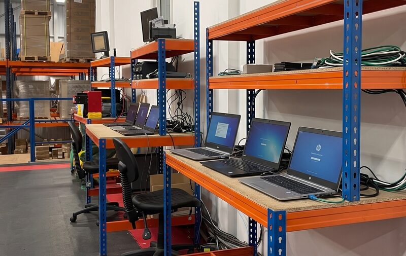 Laptops connected to wiping stations on the processing benches at the Revolve ITAD facility in Sowerby Bridge